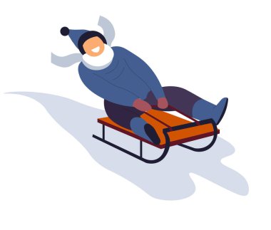 Oğlan kış tatilinde kızakla kayıyor. 