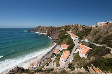 Aljezur, Portugal - April 27, 2018: Elevated view of the Arrifana Beach in Aljezur, Algarve, Portugal. The beach of Praia da Arrifana is inside the Vicentine Coast Natural Park, an area of outstanding natural beauty.  clipart
