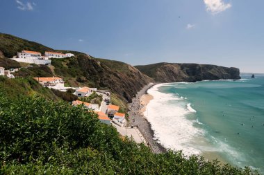Aljezur, Portugal - April 27, 2018: Elevated view of the Arrifana Beach in Aljezur, Algarve, Portugal. The beach of Praia da Arrifana is inside the Vicentine Coast Natural Park, an area of outstanding natural beauty.  clipart