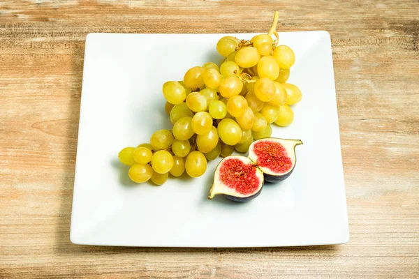 Higos frescos maduros y uvas en un tazón . — Foto de Stock