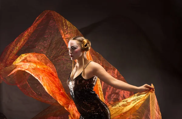 Portrait of a dancing young woman with flying fabric — Stock Photo, Image