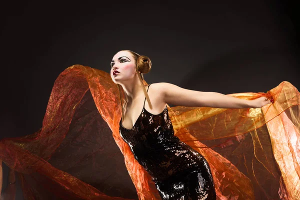 Portrait of a dancing young woman with flying fabric — Stock Photo, Image