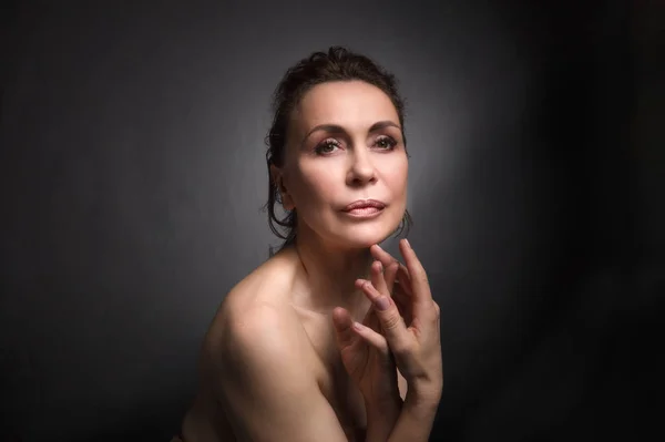 Retrato de una sensual mujer de cincuenta años sobre fondo gris de estudio — Foto de Stock