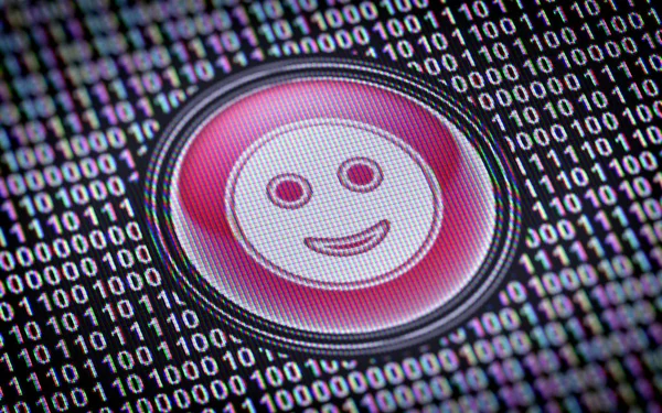 Smile icon on screen surrounded with binary code