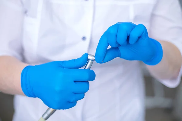 Dental drill in the hands of the dentist