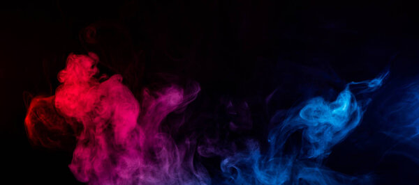 Abstract shapes of mixed colors of blue and red smoke at dark background