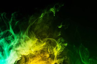 abstract yellow and green smoke on black background clipart