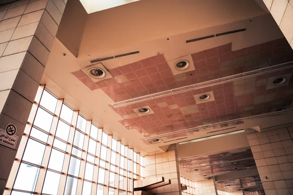 airport building ceiling with windows and fans
