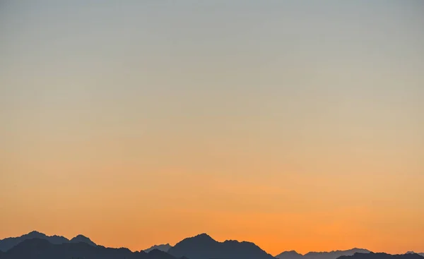 horizon line over mountains at summer sunset