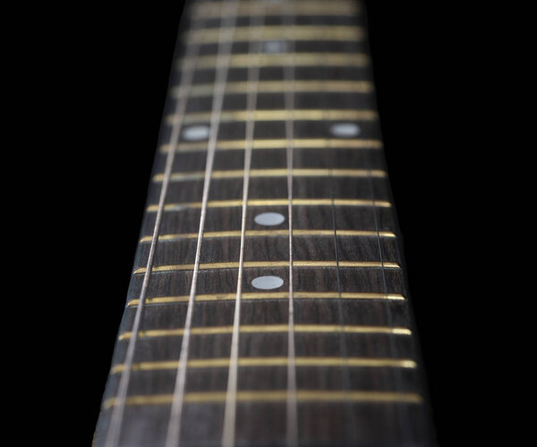 Very Nice closeup of a acoustic Guitar fretboard on Black