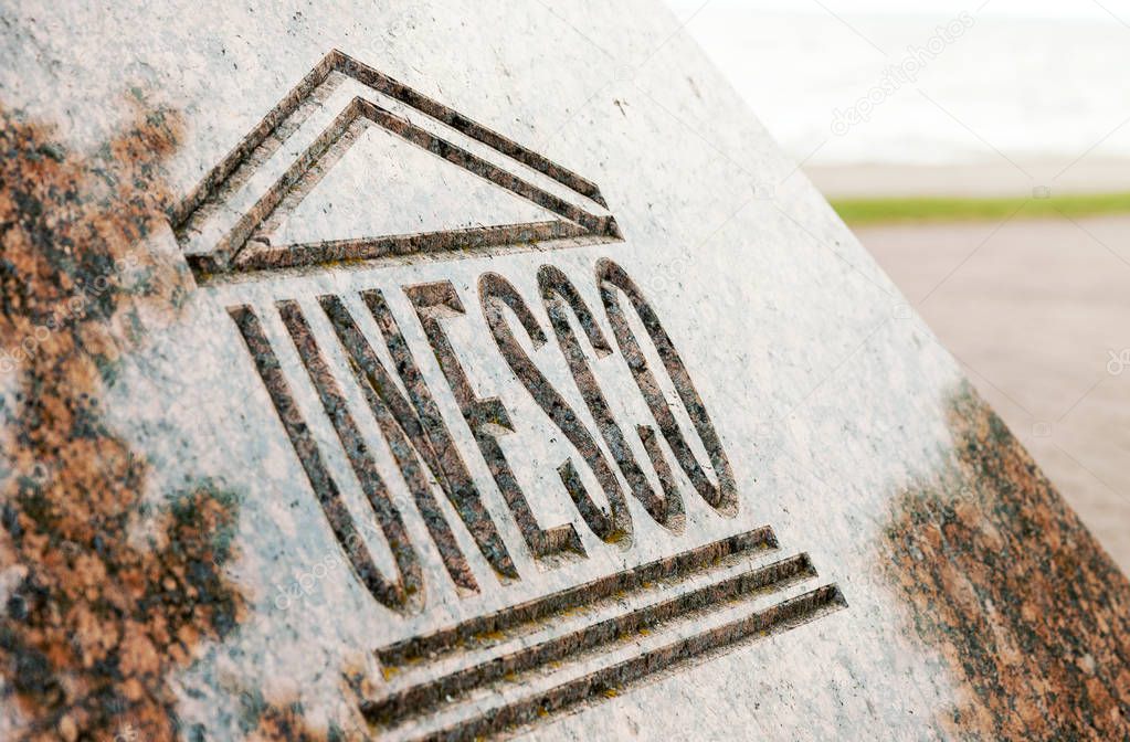 Close up of UNESCO world heritage sign carved on stone