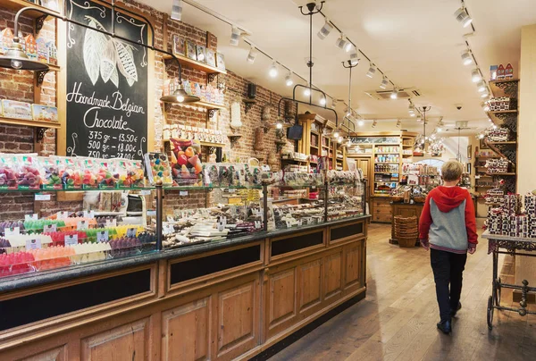 Bruges, Belgium - 27 August, 2018: Traditional cozy Belgian chocolate store interior with variey of candies and sweets to choose from in the old town of Bruges, Belgium