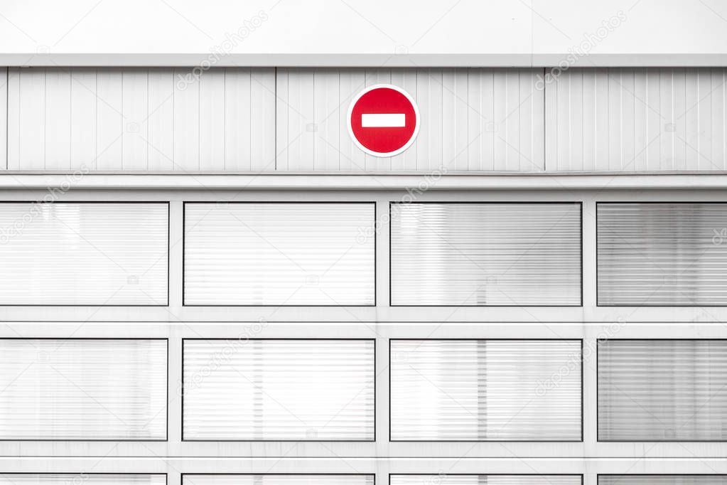 No entry traffic sign on gray industrial wall