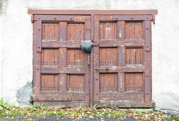 Front view of old abandoned wooden garage doors