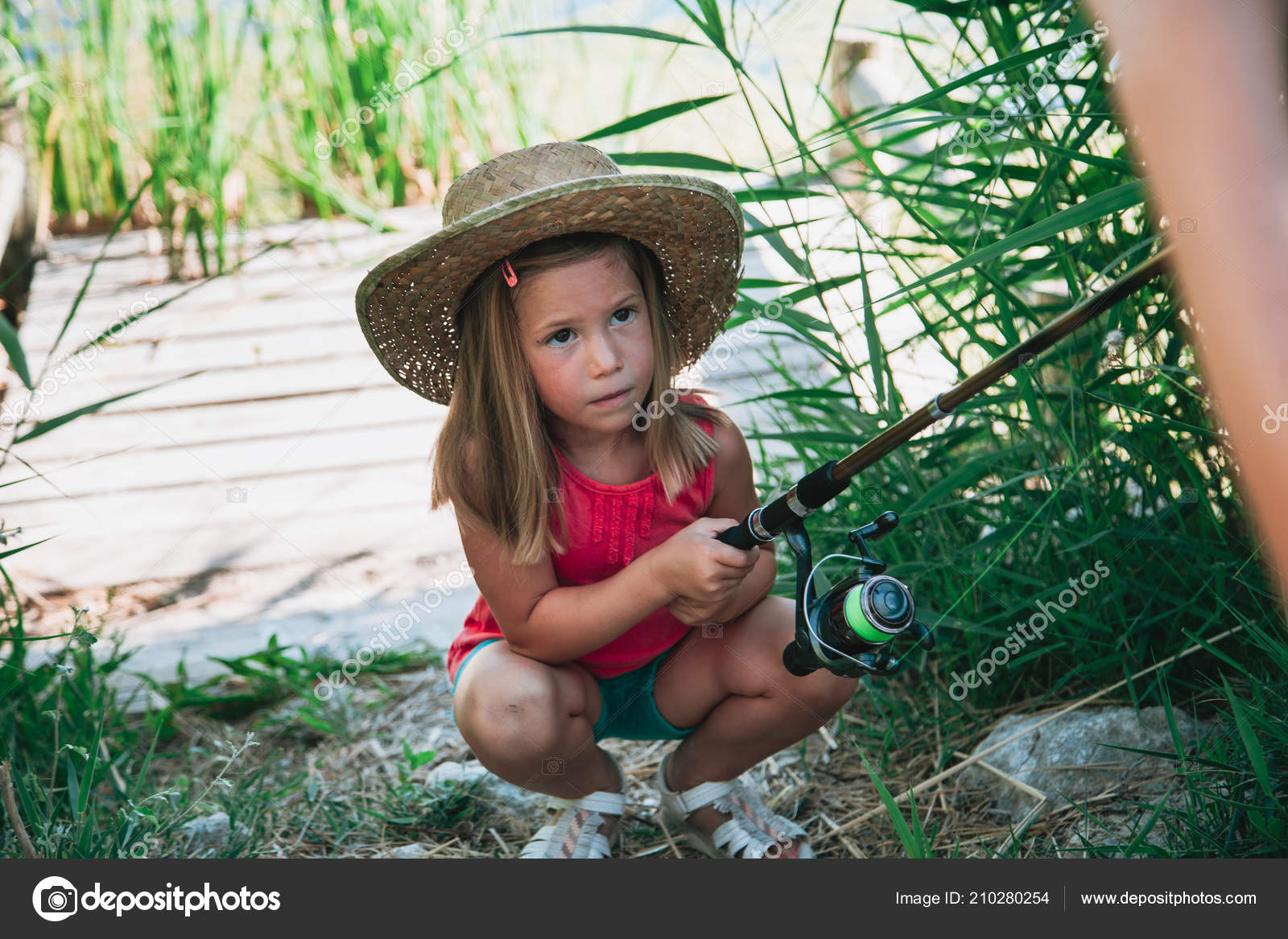 Little Blond Girl Straw Hat Prepares Her Fishing Rod Sitting Stock Photo by  ©vientocuatroestudio 210280254