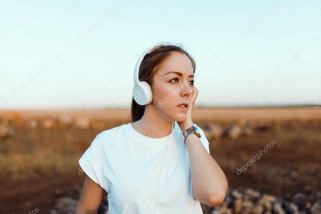 Young woman with her headphones listened external communications