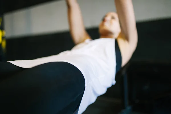 Bella donna muscolare che fa esercizio con sistema trx — Foto Stock