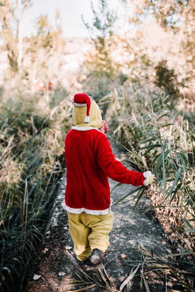 Gutt forkledd for julen i skogen med familien sin – stockfoto