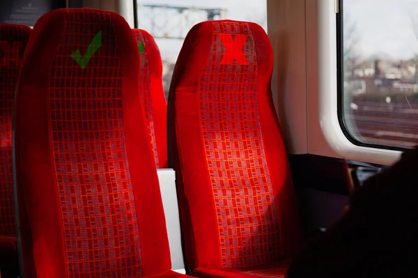 Train seats with warning marks for social distancing due to coronavirus