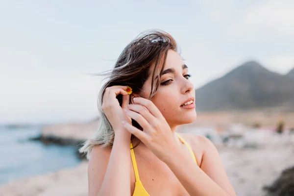 Mulher na praia vestindo maiô amarelo — Fotografia de Stock