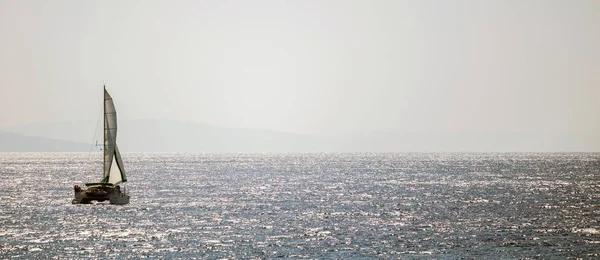 Sailboat Travels Wind Help Calm Sea Bokeh Sun Light Mountains — Stock Photo, Image