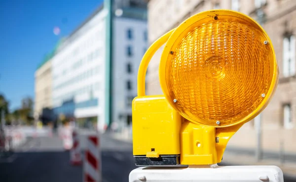 Road Construction Concept Orange Caution Light Protects Drivers Blur City — Stock Photo, Image