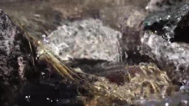 Su kristal berrak dağ deresinin orjinal sesi uzak dağlık alp ortamında aşınmış kayaların üzerinde çağlıyor. Dağcılar ve dağcılar için engebeli arazi ve temel su kaynağı.