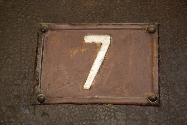 Number Seven on Metal Background