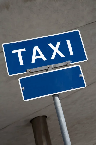 Blue Taxi Sign in Urban Setting