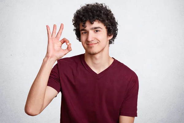 Young Handsome Male Curly Hair Makes Okay Sign Shows His — Stock Photo, Image