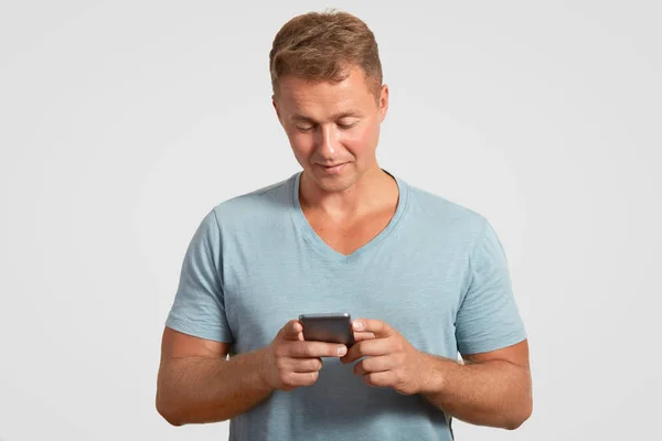 Serious Attractive Man Holds Modern Smart Phone Texts Messages Checks — Stock Photo, Image