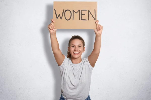 Positive Young Female Dressed Casual Shirt Holds Plate Inscription Women — Stock Photo, Image