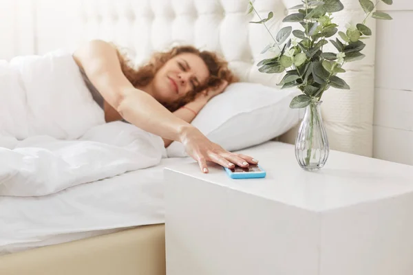 Sad Displeased Woman Wakes Early Morning Turns Alarm Clock Smart — Stock Photo, Image