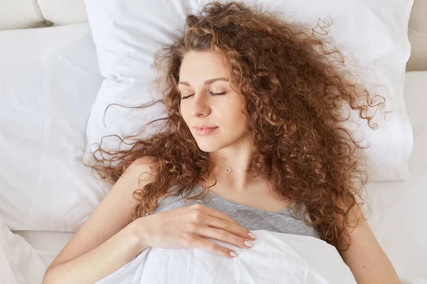 Top View Relaxed Curly Woman Has Healthy Sleep Bed Lies — Stock Photo, Image