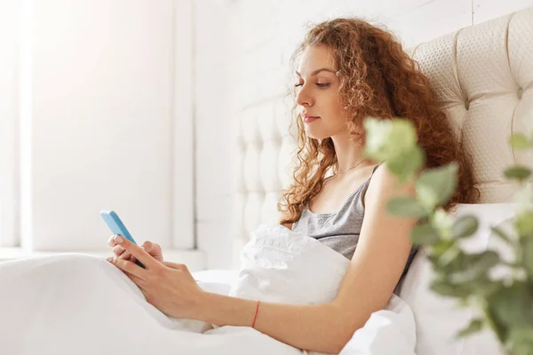 Sideways Portrait Serious Female Attractive Look Sits White Soft Bedclothes — Stock Photo, Image