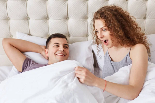 Shocked Female Looks White Blanket Being Surprised Size Boyfriend Genitails — Stock Photo, Image