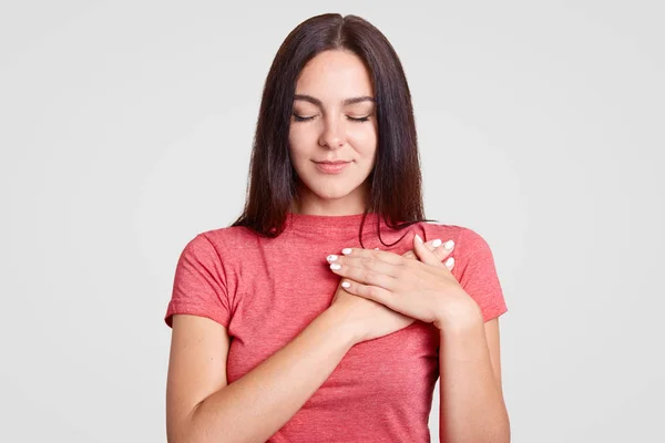 Calm Brunette Female Closed Eyes Keeps Both Palms Heart Feels Royalty Free Stock Photos