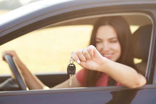 Happy Young Brunette Female Holds Key While Sits Luxury Automobile — Stock Photo, Image