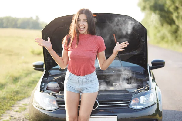 Outdoor Shot Puzzled Young Female Driver Gestures Angrily Being Stressed — Stock Photo, Image