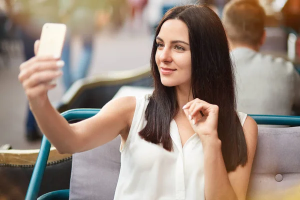 Satisfied Beautiful Girl Makes Selfie Smart Phone Takes Picture Herself — Stock Photo, Image