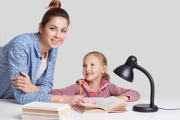 Sonriente Niña Encantadora Sienta Mesa Hace Tarea Junto Con Madre —  Fotos de Stock