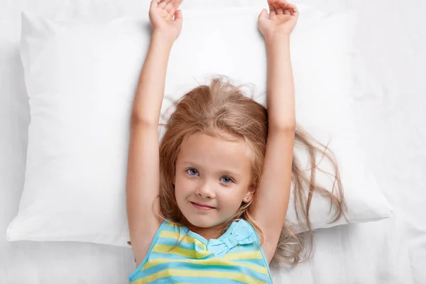 Top View Pretty Child Has Long Hair Stretches Bed Lies — Stock Photo, Image