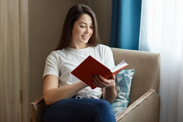 Pretty Young Woman Sits Comfortable Armchair Reads Interesting Book Dressed — Stock Photo, Image