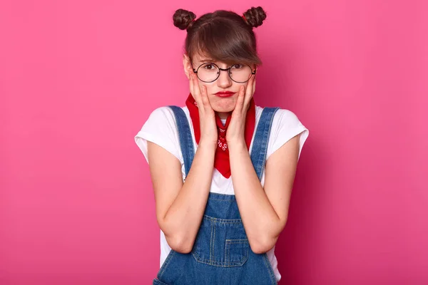 Retrato de menina adolescente infeliz ofendido com lábios malvados, mantém as mãos nas bochechas, descontente com tudo, se sente frustrado e chateado, modelo posa sobre fundo rosa, espaço de cópia para o seu texto . — Fotografia de Stock