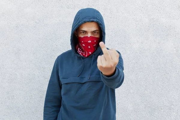 Close up photo of young guy in bandana mask calls for stopping police brutality, showing fuck symbol, fight for equal rights and against racism isolated over white background.