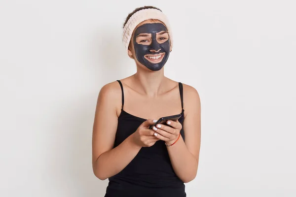 Vrolijk Lachende Vrouw Met Zwart Cosmetisch Masker Direct Naar Camera — Stockfoto