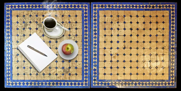 Notepad on Two moroccan mosaic table, view from above