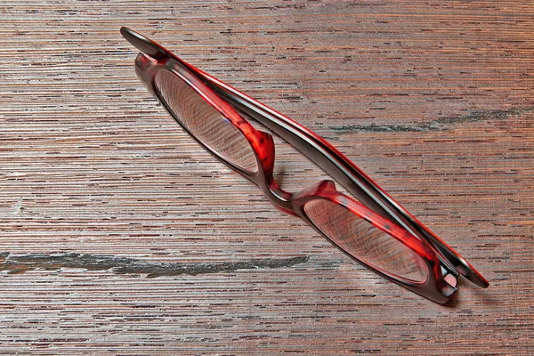 Elegant Eyeglasses Brown Wooden Table Reflections Shadows View — Stock Photo, Image