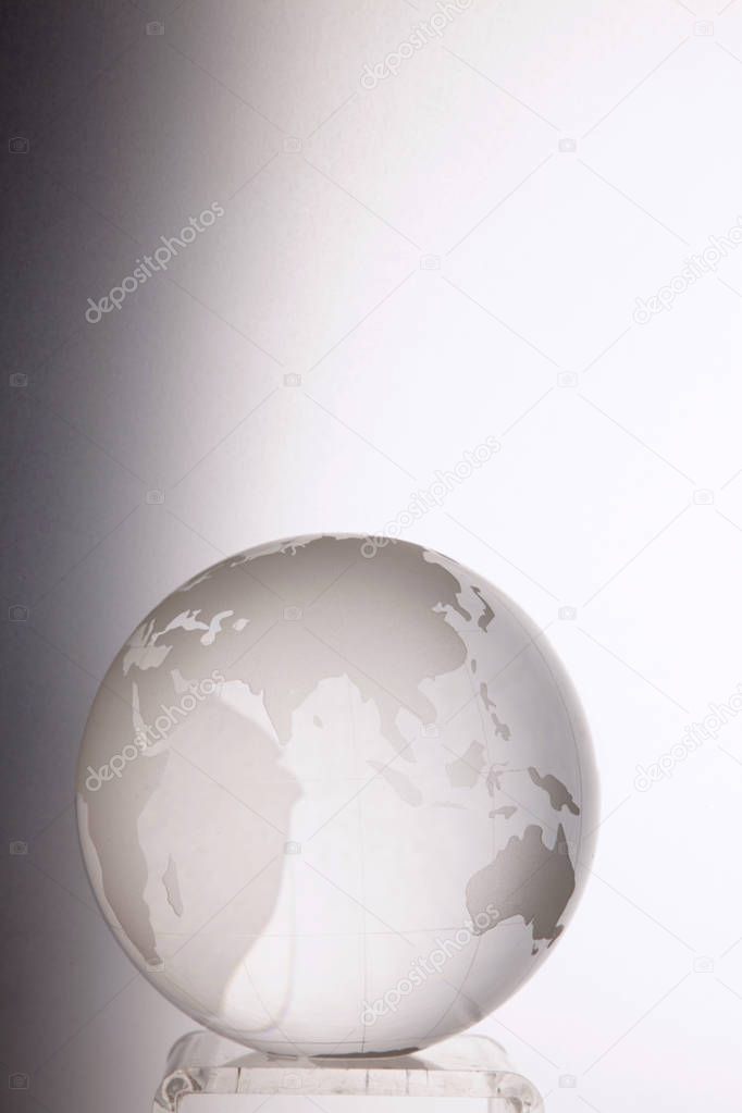 close up of glass globe on grey background