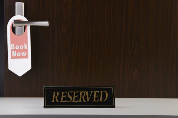 reserved sign at the hotel reception counter